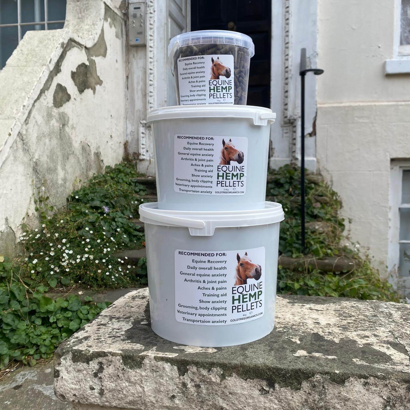 Gold Tree Organics Equine Hemp Pellets in stackable containers for equine health and nutrition