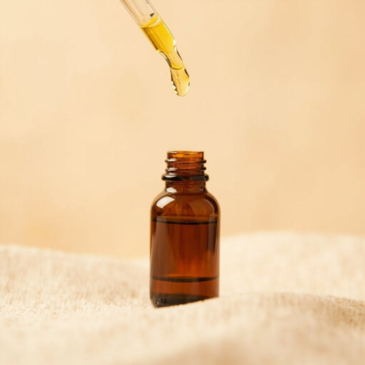 Amber CBD oil dropper bottle on a neutral background showing how CBD oil is made