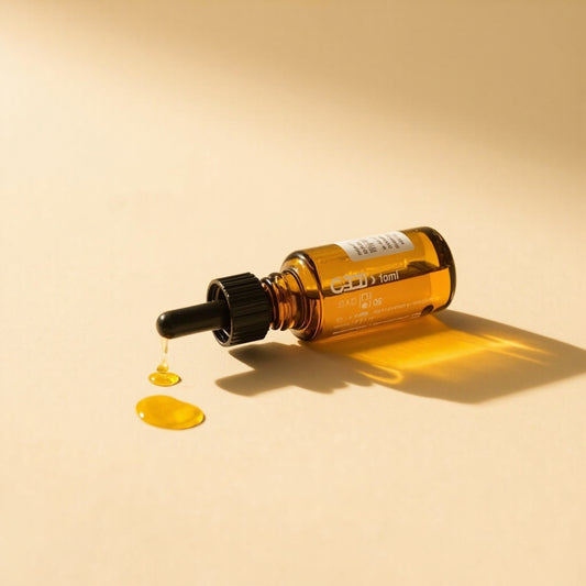 CBD oil dropper with golden MCT carrier oil close-up