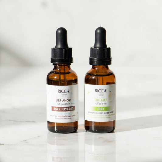 Two CBD oil dropper bottles side by side comparing full spectrum and broad spectrum