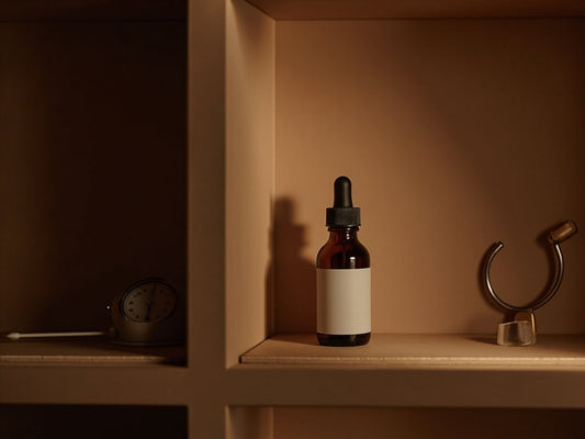 Amber CBD dropper bottles on dark wood shelf for storage shelf life guide