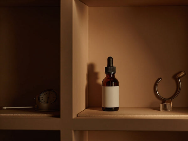 Amber CBD dropper bottles on dark wood shelf for storage shelf life guide